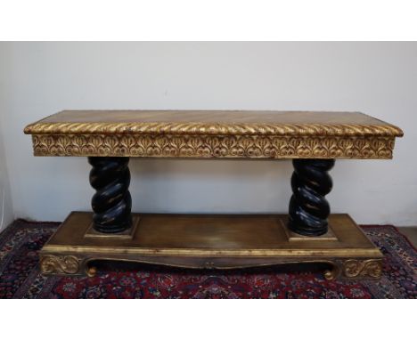 A gilt decorated and parquetry console table, the rectangular top with a gadrooned edge above a heart and scrolling frieze on