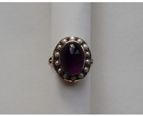 A 9ct yellow gold dress ring, with a cabochon amethyst surrounded by pearls, size P, approximately 7.5 grams