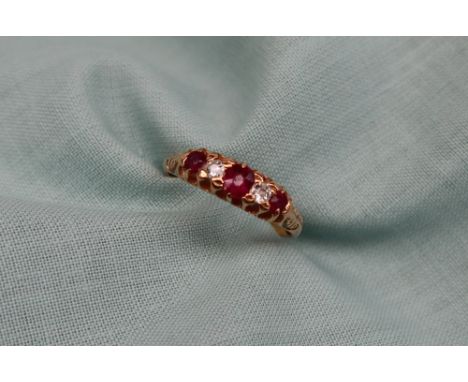 A ruby and diamond line ring, set with three rubies and two diamonds to a yellow metal setting and shank, size N, approximate