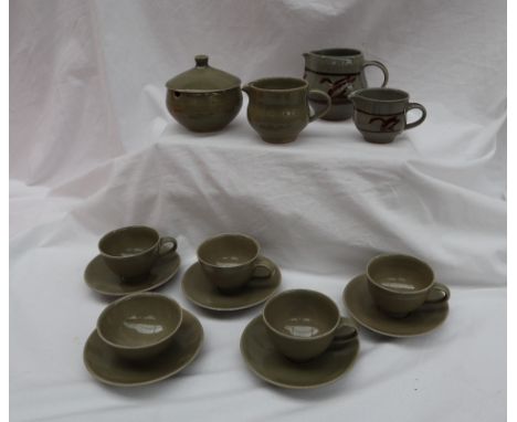 A Harry Davies for Crowan pottery part tea set comprising four tea cups, a tea bowl, five saucers, sugar box and cover and a 