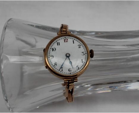 A 15ct yellow gold Lady's wristwatch, the white enamel dial with Arabic numerals on an expanding bracelet strap, overall appr