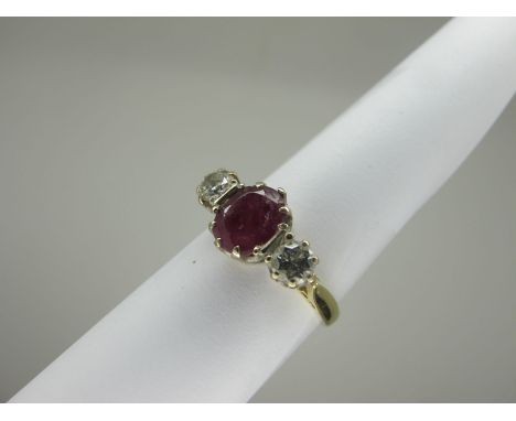 An 18ct Gold Ruby and Diamond Three Stone Ring, oval four claw set to the centre (wear to stone), between two brilliant cut d