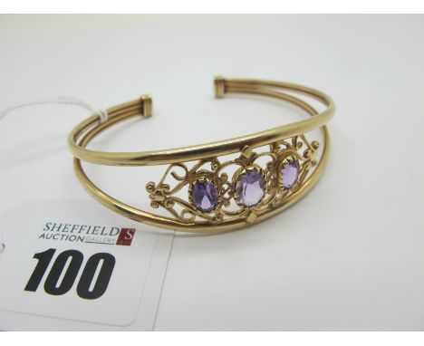 A Decorative 9ct Gold Bangle, of openwork design, with graduated highlights, between scroll style border, (11grams).