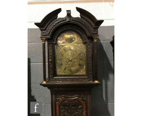 A 19th Century carved oak longcase clock with an 8-day movement, the later associated 11 inch modified 'raised' arch brass di