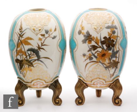 A pair of late 19th Century Royal Worcester egg shaped vases, raised to three scroll feet, each decorated with Aesthetic flow
