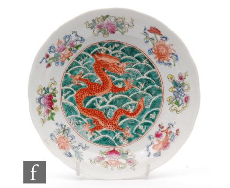 A Chinese famille verte Dragon dish of scalloped circular form, the central reserve painted with an iron red four-clawed drag