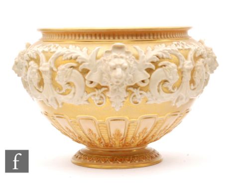 A Royal Worcester shape 1310 jardiniere decorated with a band of relief moulded lion heads, scrolls and fauns in white agains