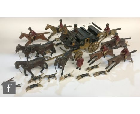 A 1930s painted wooden model of the Worcester stage coach with a four horse team and occupants and a similar primitive carved