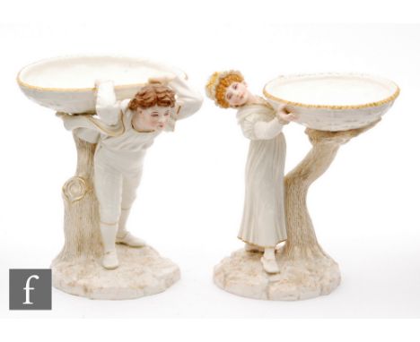 A pair of late 19th Century Royal Worcester sweet meat dishes modelled by James Hadley, she holding her basket aloft, he pull