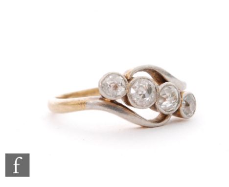 A mid 20th Century 18ct diamond four stone ring, millgrain set stones to a slight twist, ring size K 1/2. 