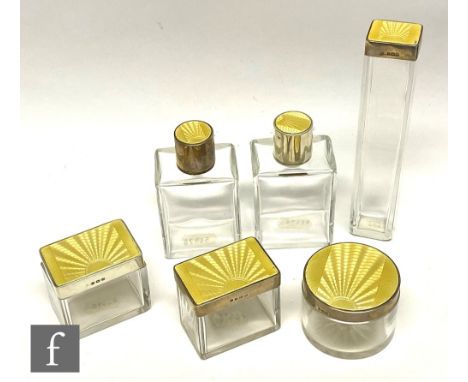 A collection of Art Deco guilloche enamel and silver topped ladies cosmetic jars, the clear glass jars of circular and square