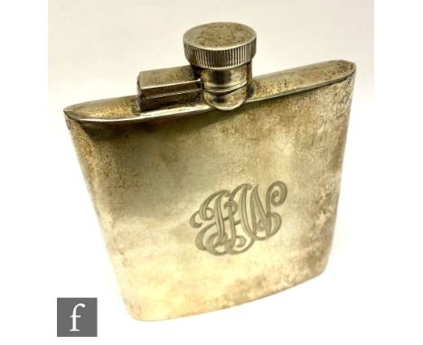 A 1930s hallmarked silver hip flask of cushioned rectangular form terminating in a bayonet cap, engraved monogram to front, h