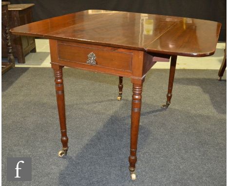 A George IV mahogany Pembroke table with single end drawer on ring turned legs and castors, height 72cm x 101cm opened. 