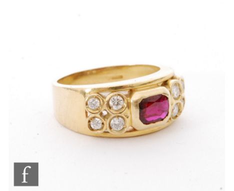 An 18ct ruby and diamond ring, central collar set emerald cut ruby flanked by four collar set diamonds top either side, weigh