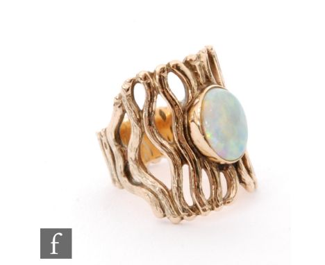 A modern 9ct opal ring single collar set oval stone to a pierced bark effect shank, weight 10g, ring size M. 