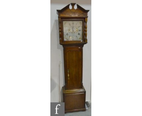 A 19th Century oak and mahogany crossbanded longcase clock with an eight day movement striking on a bell, the architectural c