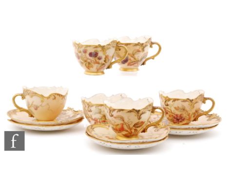A set of six Royal Worcester shape 1471 teacups and saucers, each decorated with fruits and berries and floral sprays with gi