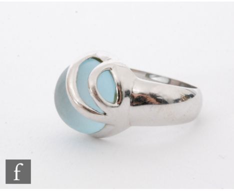 A 14ct white gold single stone ring set with a pale blue cabochon collar stone, weight 8.6, ring size O 1/2. 