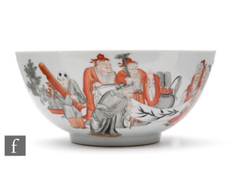 A Chinese enamelled bowl painted with a scene of immortal figures and attendants inspecting a scroll, glazed turquoise to the