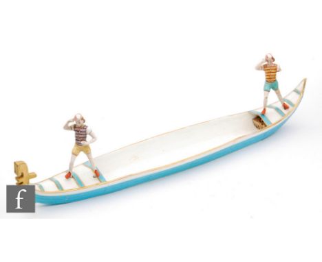 A late 19th Century novelty table centre modelled as a gondola with two female gondolier, the gondola in turquoise enamel wit