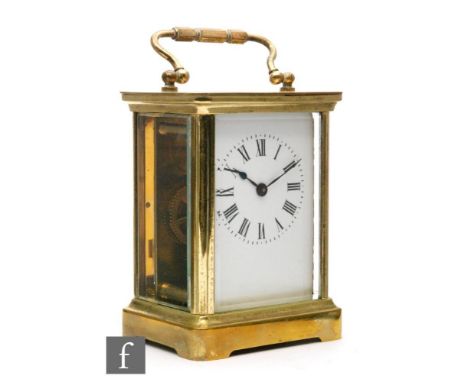 An early 20th Century brass and bevelled glass carriage clock, with white enamelled dial, movement unsigned, height excluding
