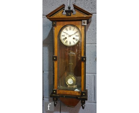 A late 19th Century walnut and part ebonised regulator wall clock, the architectural pediment over a circular dial and spring