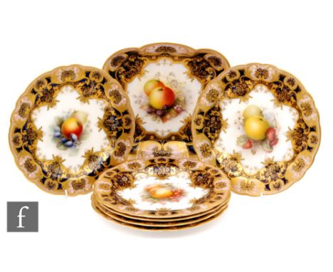 An Edwardian Royal Worcester dessert service decorated by Seabright with hand painted fruits and berries with a dark blue and