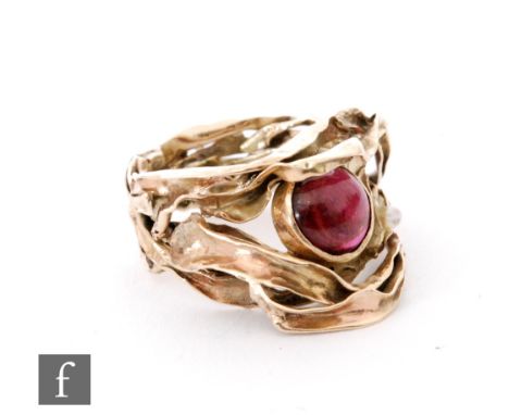 A 9ct hallmarked garnet and freshwater pearl ring, the central collar set garnet and off set pearl to a folded strip gold sha