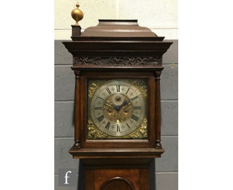 A late 18th Century oak longcase clock with associated eight-day movement striking on a bell, the 12 inch brass dial with dec