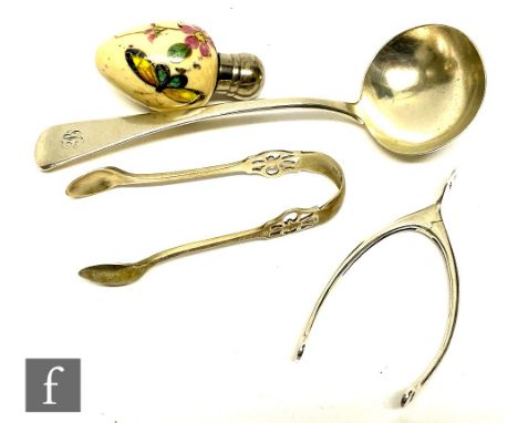 A collection of silver items to include, to include a pair of wishbone sugar tongs, London 1908, Henry Stuart Brown, together