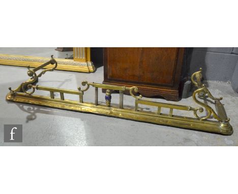 An Edwardian Art Nouveau style brass fender pierced scroll frame on a stepped base, length 134cm. 