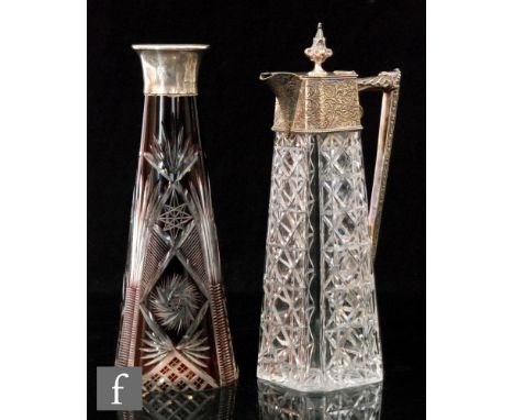 An early 20th Century glass carafe with hallmarked silver collar, of conical form, the clear crystal cased in ruby and flash 