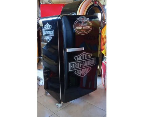 Harley Davidson themed fridge on 4 rotating wheels. Works well and keeps cool. Size: 110 x 53 x 55 cm. Condition: Excellent.