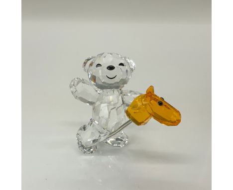 This playful Kris Bear is full of joy. Sparkling in clear crystal, he rides his hobby horse. Swarovski swan backstamp. This i