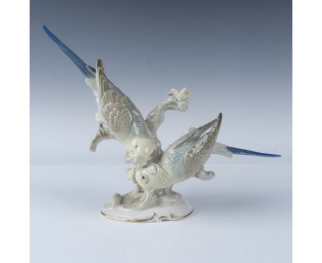 Glossy porcelain figurine depicting two parakeets perched on a delicately sculpted branch. Hutschenreuther backstamp and arti