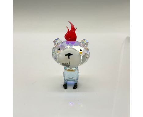 This whimsical character is crafted in vibrant red and lilac crystal, featuring an iridescent head and body, fiery red hair, 