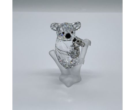 Part of the Rare Encounters collection. A mother koala in clear faceted crystal cradling her little cub in Golden Teak crysta