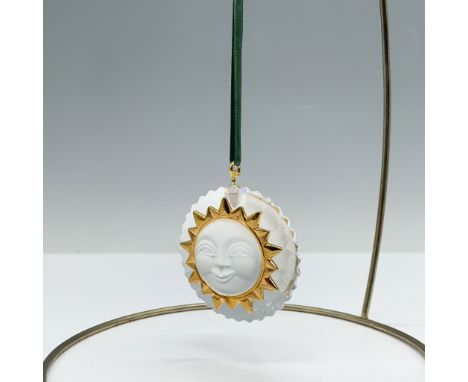 Beautiful clear crystal ornament with a frosted face that features a radiant sunburst motif, symbolizing light, hope, and joy