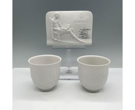 This lot features a Lladro Collector's Society plaque alongside two porcelain cups, all crafted in Lladro's signature matte w