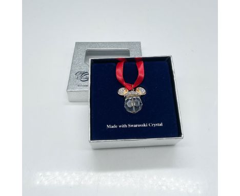 This Swarovski Disney Mickey Mouse ornament is crafted with precision-cut Swarovski crystal elements, showcasing the iconic M