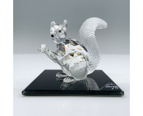 Adorable, limited edition crystal figure with frosted crystal bushy tail holding his crystal chaton, looking out with jet cry