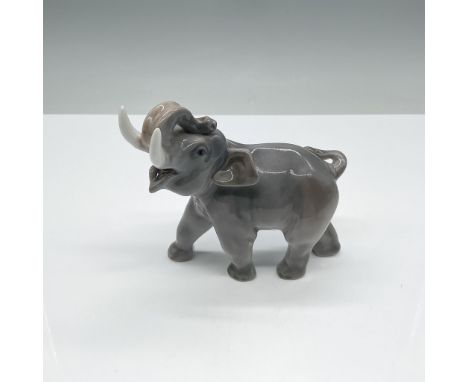 Royal Copenhagen porcelain figurine of a playful elephant with its trunk raised, model number 2498. Known for its exquisite c