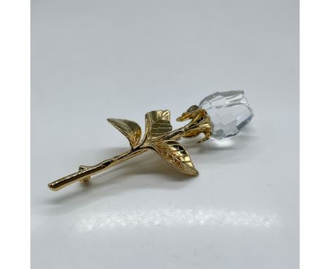 Lovely crystal rose bud set on gold plated stem and leaves. Swarovski impressed mark. 9446 930 001. This item has its origina