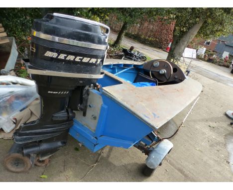 A VINTAGE SPEEDBOAT WITH MERCURY OUT BOARD ENGINE.
