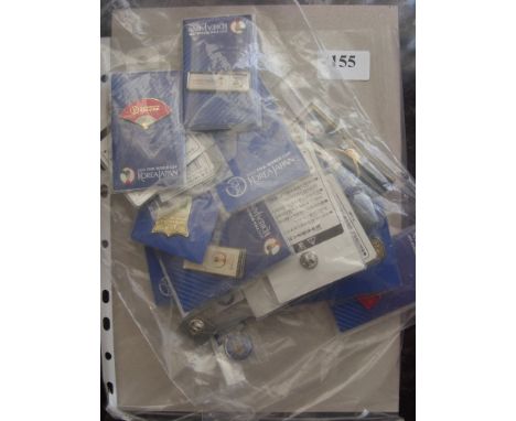 A collection of 27 football badges, mainly from the 2002 World Cup, but also include a 1950 World Cup 'Uruguay Champions Of T
