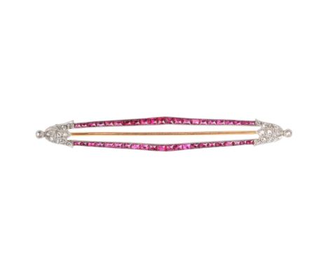A French Art Deco 18ct gold and platinum ruby and diamond geometric brooch, circa 1920, the lozenge frame channel set with gr