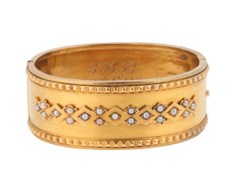 An Antique Victorian Etruscan Revival 18ct gold split pearl hinged bangle, circa 1860, band width 24.1mm, internal circumfere