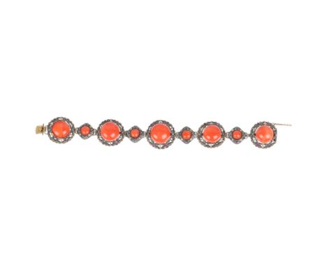 An Antique Continental silver coral panel bracelet, circa 1900, each domed floral panel set with alternating size button cora