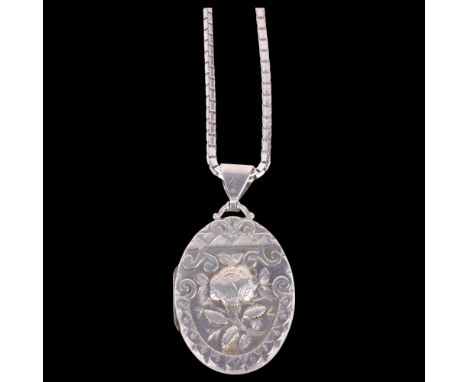 A Victorian silver floral locket pendant necklace, by Constantine & Floyd, Birmingham 1885, oval form with relief embossed de