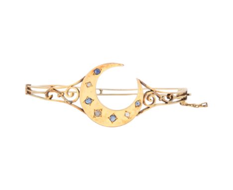 An Antique Victorian 9ct gold sapphire and diamond crescent moon hinged bangle, circa 1900, set with oval-cut sapphires and o